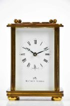MATTHEW NORMAN; a brass cased carriage clock, the dial set with Roman numerals, height 14cm.