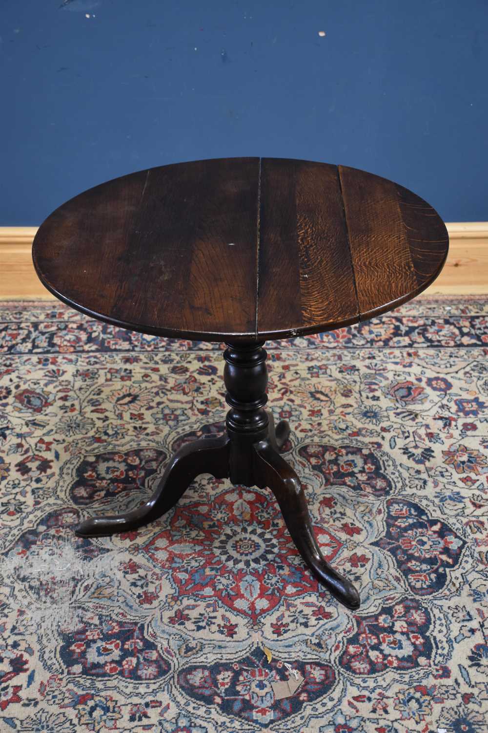 An 18th century oak tilt-top tripod table, height 69cm