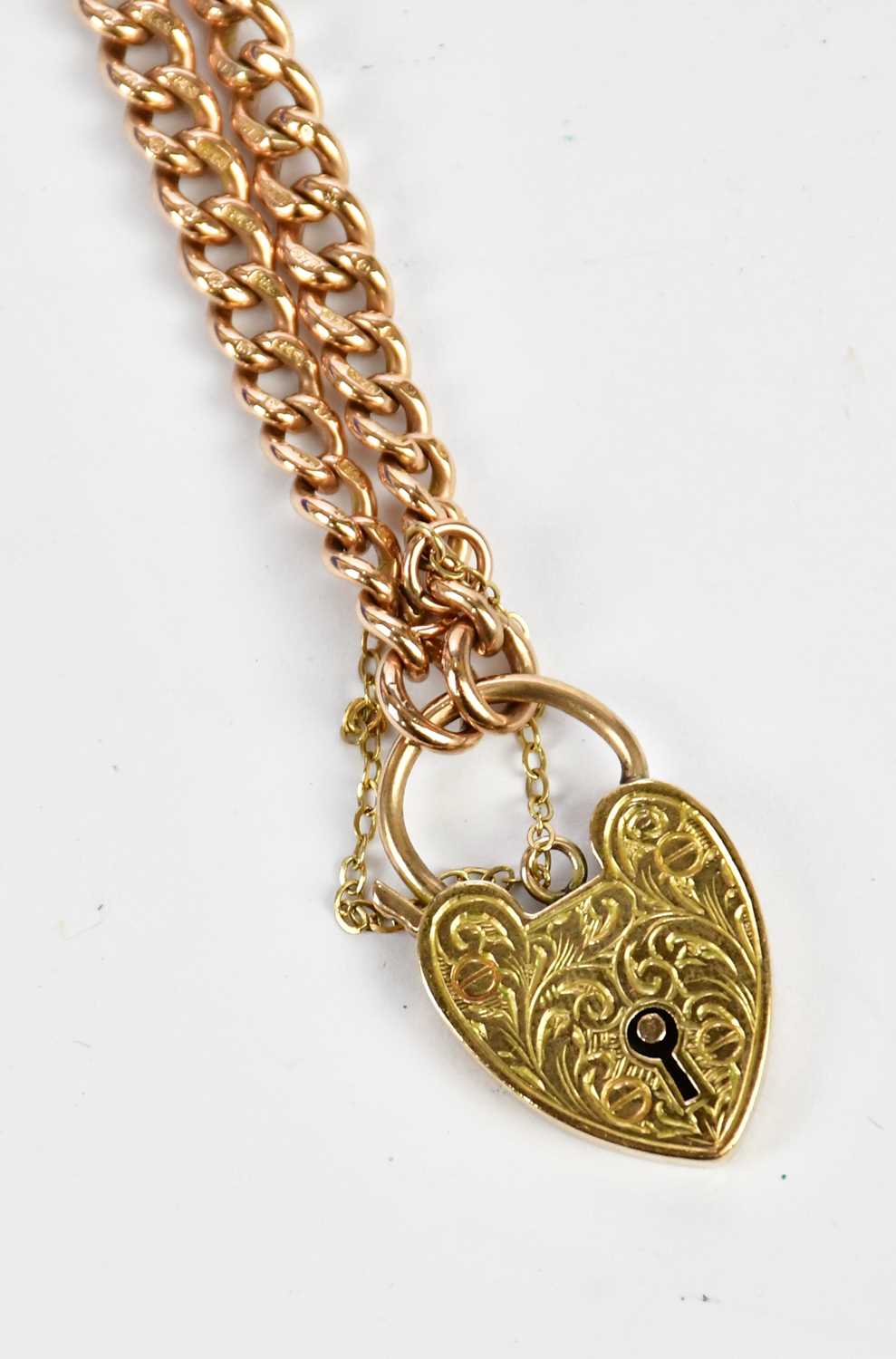 A 9ct graduated rose gold bracelet with substantial padlock clasp, combined approx 21.8g.