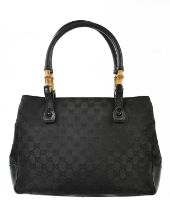 GUCCI; a black GG medium monogram canvas bamboo and black leather handle, with leather base, with