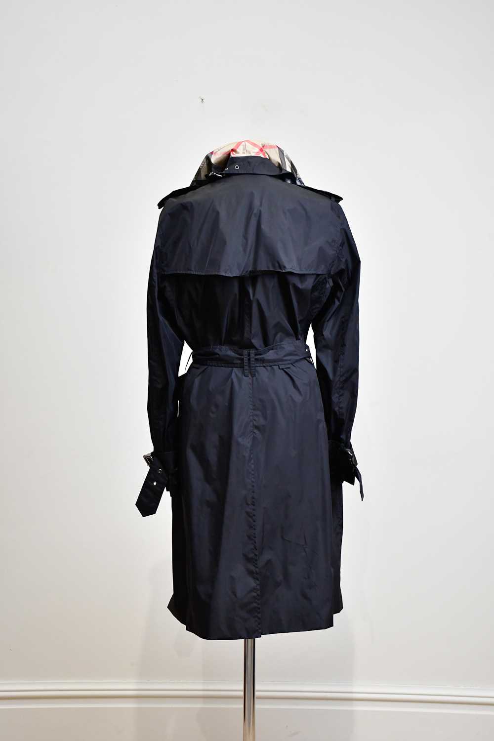 BURBERRY; a full length black mac trench coat with part Nova check lining, belt and collar, size 14. - Image 2 of 3