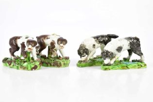 STAFFORDSHIRE; two identical late 18th century pearlware figures of dogs, height 8cm, length 12cm,