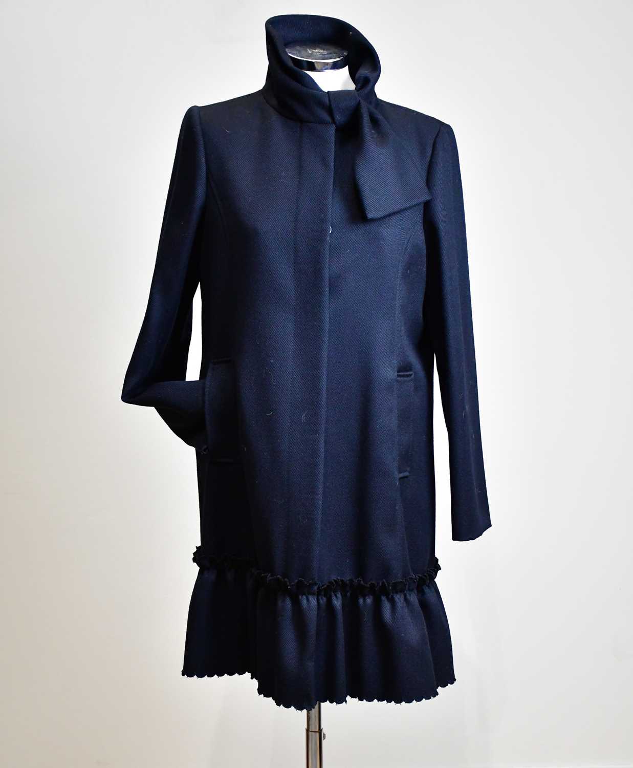 RED VALENTINO; a 100% wool black lady's short coat with frill to the bottom, front buttons, fully