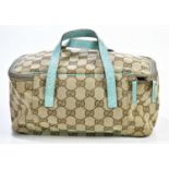 GUCCI; a GG canvas small vanity cosmetic bag with turquoise blue trim, top handles and lined in