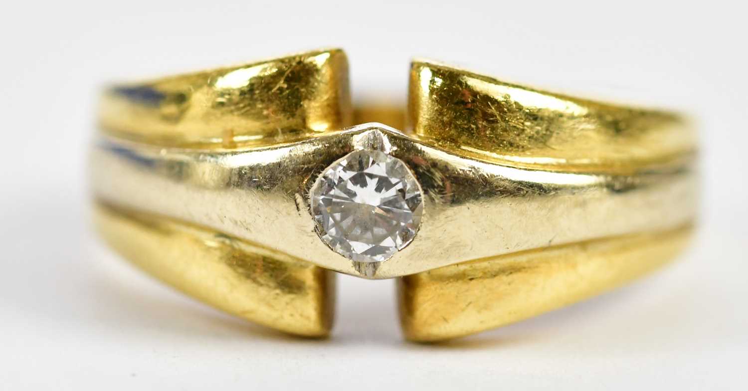 An 18ct yellow and white gold diamond ring, the collet set round brilliant cut stone weighing