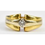 An 18ct yellow and white gold diamond ring, the collet set round brilliant cut stone weighing