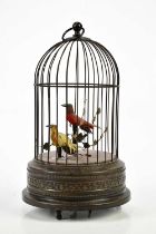 A decorative bird automation of two singing birds in a cage, height 28cm. Condition Report: Good