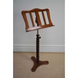 A reproduction adjustable mahogany music stand, height 118cm.