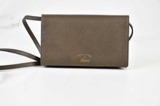 GUCCI; an unused pebbled brown leather crossbody shoulder bag wallet, with front flap lined in