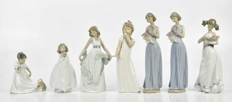 NAO; a collection of seven figures including two maidens in blue dresses holding flowers, a girl