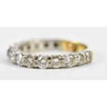 A yellow and white metal diamond three-quarter eternity ring set with fourteen round brilliant cut