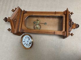 G. P. WEHLEN & CO; an oak cased wall clock, the white enamel dial set with Roman numerals, height