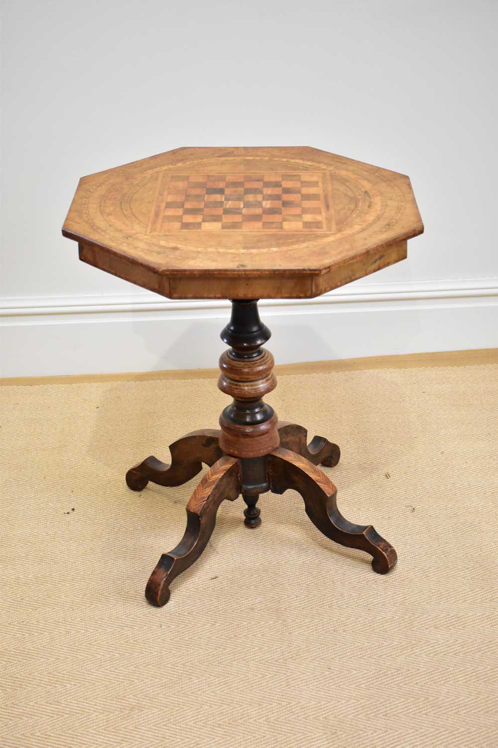 A Victorian octagonal top occasional table with chessboard top, height 74cm.