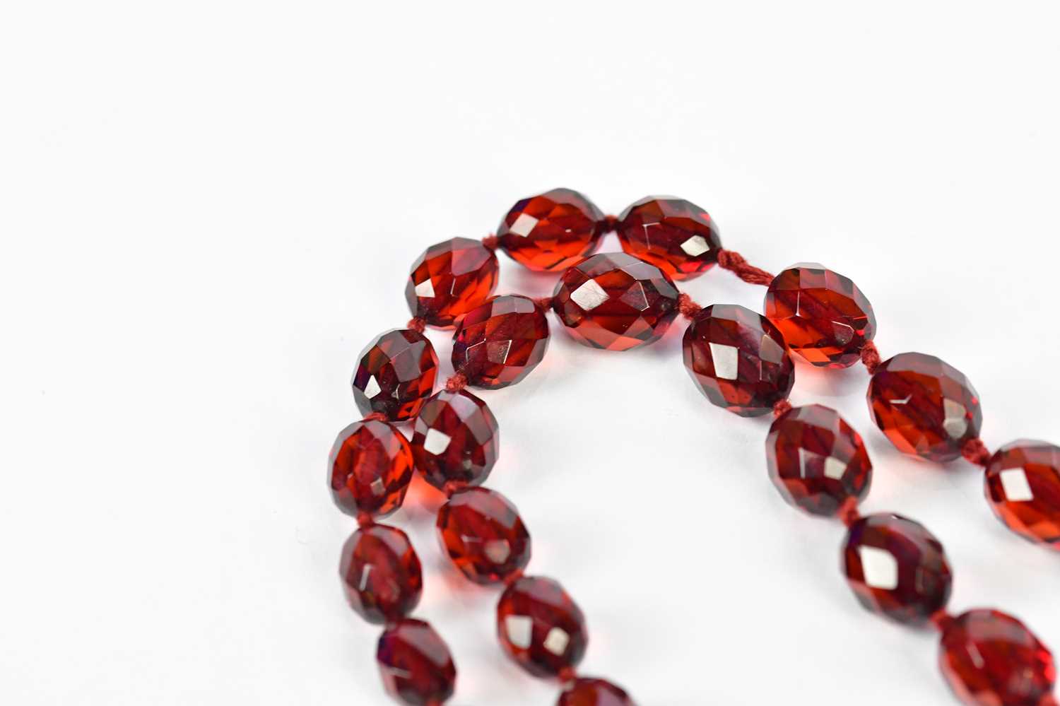 A cherry amber facet cut graduated bead necklace, length 88cm, approx 58.6g. - Image 5 of 5