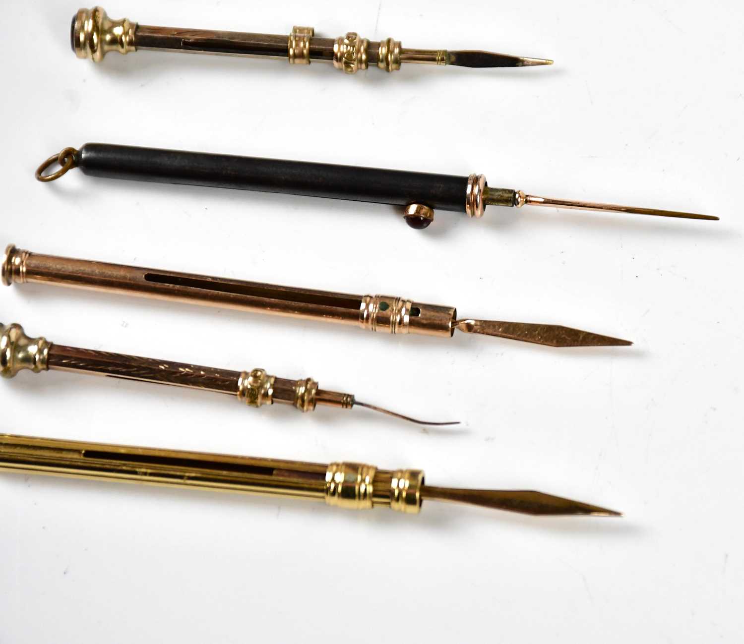 Four late 19th/early 20th century yellow metal tooth picks, including an example with cast linear - Image 3 of 3