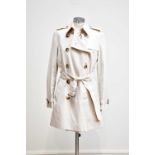 BURBERRY; a lady's short light beige trench coat mac, with Nova check lining and belt, chest