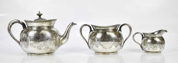 MAPPIN & WEBB; a silver plated three piece tea service with cast beaded rims and chased decoration.