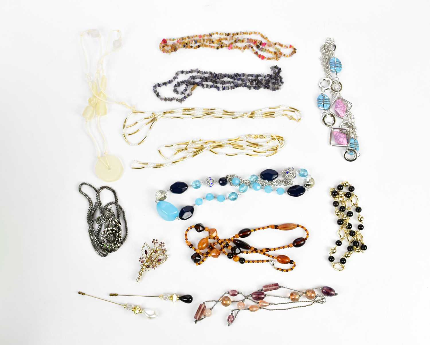 A small collection of costume jewellery including necklaces and pins.