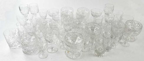 A large collection of assorted cut glasses, various shapes, including tumblers, sundae bowls, etc.