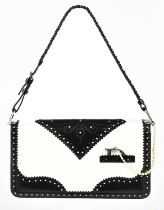 CHRISTIAN DIOR; a black and white leather D Trick wingtip Spectator handbag with a braided handle,