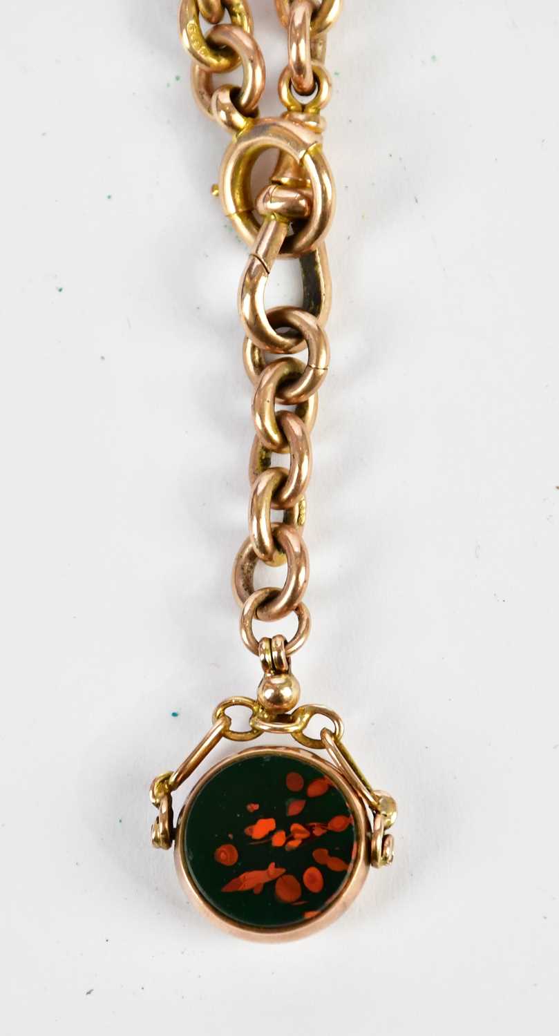 A 9ct yellow gold trombone link chain with bloodstone set swivel fob and T-bar, length 39cm,