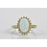 A 14ct yellow gold simulated opal and diamond cluster ring, size W, approx. 3.4g. Condition