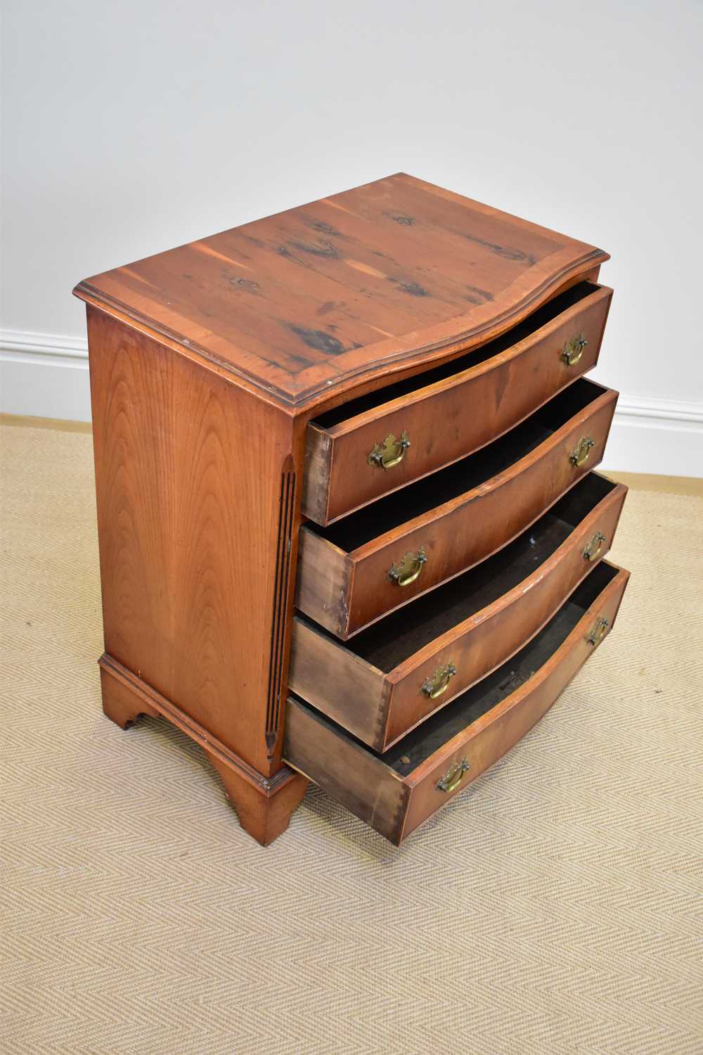 A reproduction serpentine fronted yew wood four drawer chest on bracket feet, width 72cm, depth - Image 2 of 3