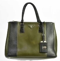 PRADA; a khaki green and black calfskin Saffiano leather city bag, with top handles, turn lock black