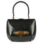 BALENCIAGA; a circa 2007 black calfskin leather Tron handbag, with large gold tone front metal