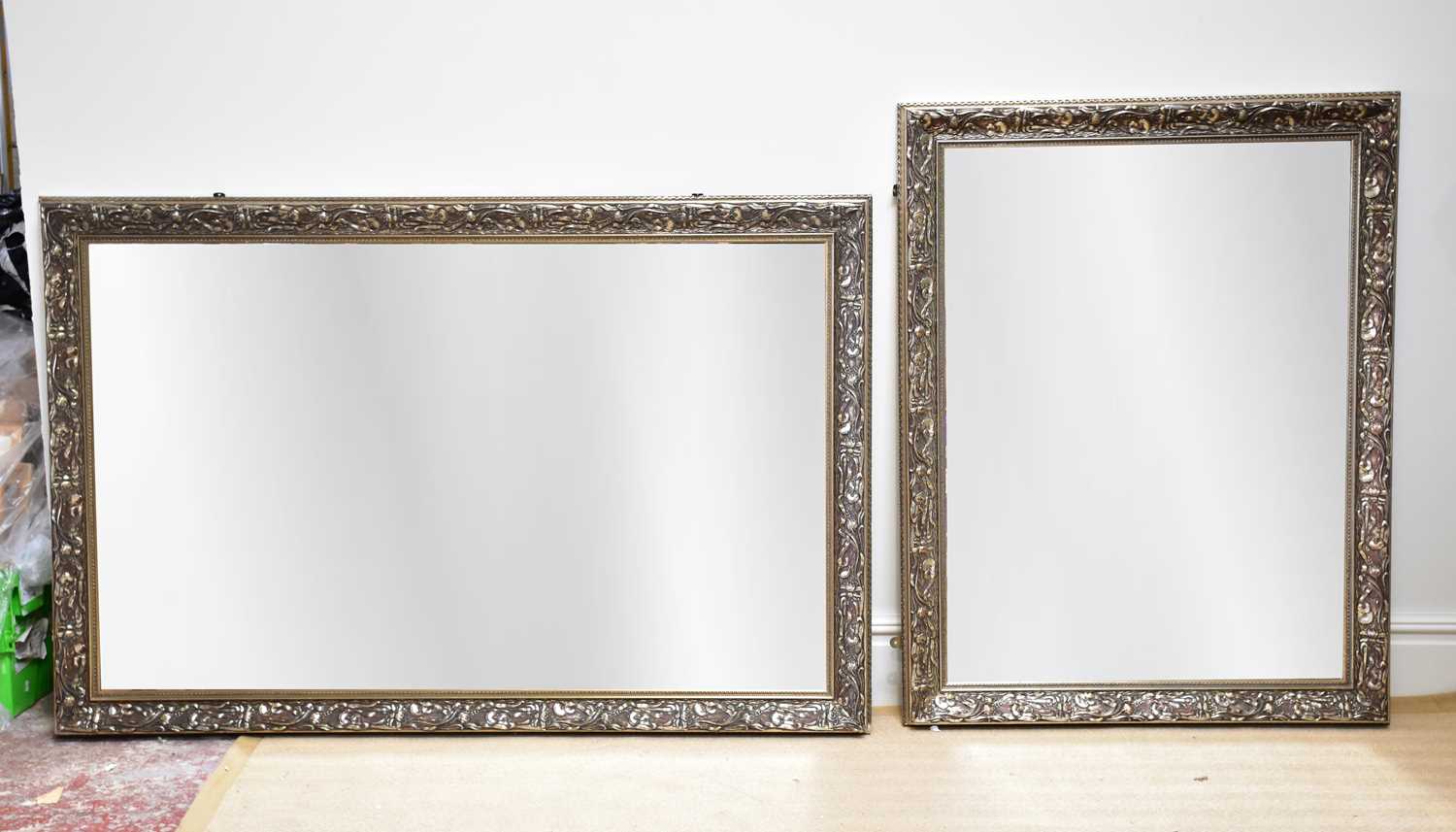 Two modern silvered wall mirrors with relief floral decoration, largest example approx. 179 x 120cm,