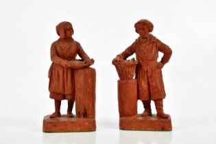 A pair of late 19th century terracotta figures representing a fisherman and fisherwoman, each with