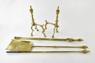 A brass companion set including a pair of dogs.