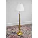 An early 20th century telescopic brass standard lamp on circular plinth base, height 126cm.