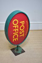 A green painted advertising post office sign for Woodford, length 73cm.