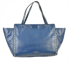 VALENTINO; a navy blue nappa leather Garavani Rock Stud medium handbag with gold tone metal studs