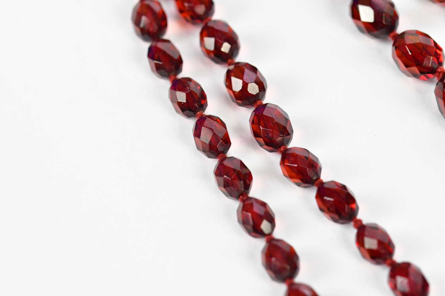 A cherry amber facet cut graduated bead necklace, length 88cm, approx 58.6g. - Image 4 of 5