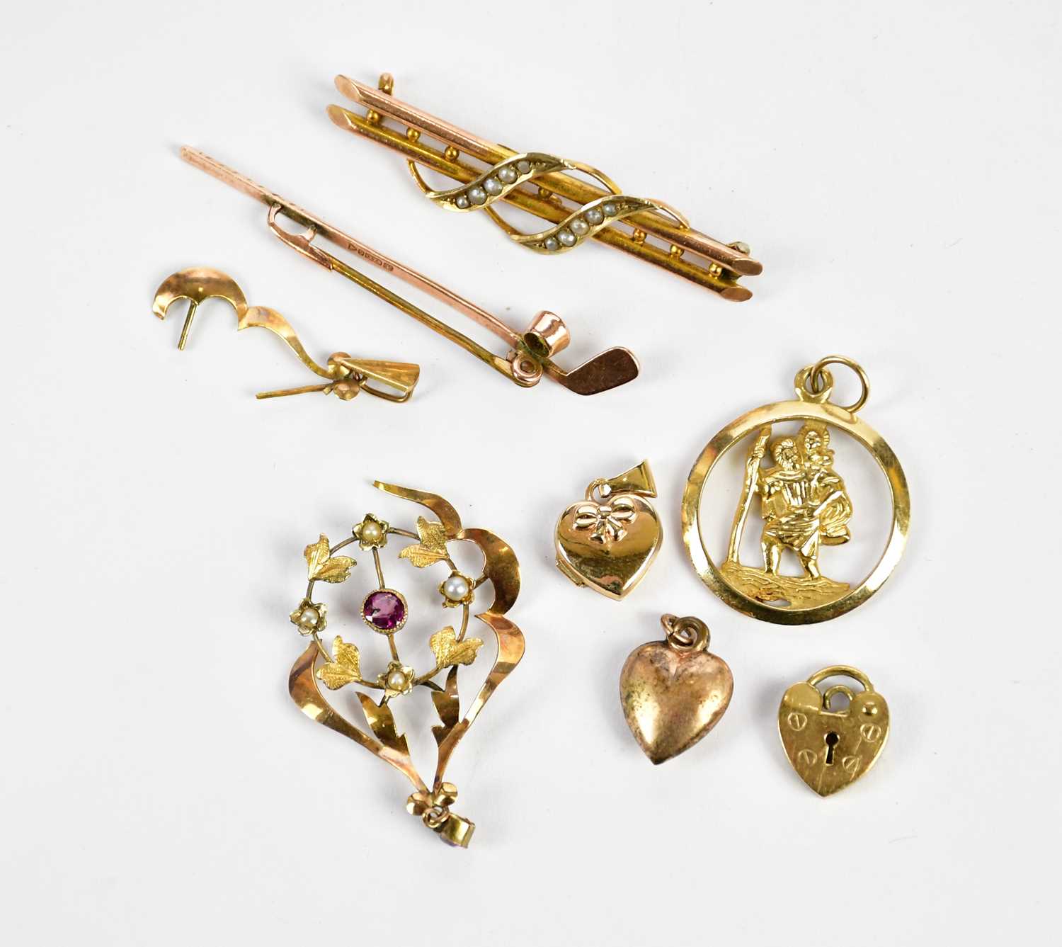 A group of 9ct gold and yellow metal comprising two brooches, a damaged Art Nouveau pendant, three