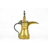 An unusual eastern Dallah brass coffee pot, with embossed decoration and touch mark, height 30cm.