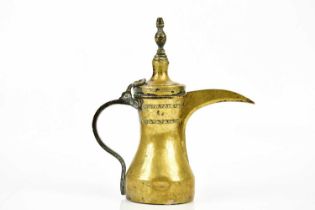 An unusual eastern Dallah brass coffee pot, with embossed decoration and touch mark, height 30cm.
