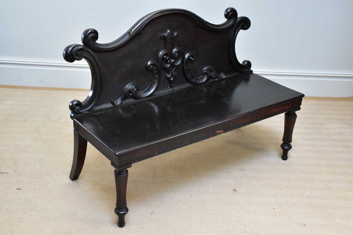 A Victorian settle with carved back on fluted front columns, width 170cm.