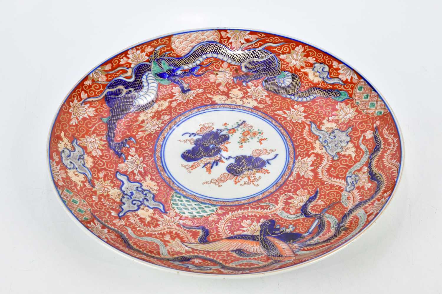 A late 19th century Japanese Imari wall charger decorated with butterflies, a three claw dragon