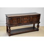 TITCHMARSH & GOODWIN; a reproduction carved oak dresser base with two drawers flanked by carved