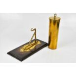 A trench art shell case dinner gong, on brass mounted wall plaque, height of shell 29cm.