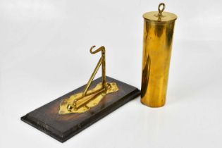 A trench art shell case dinner gong, on brass mounted wall plaque, height of shell 29cm.