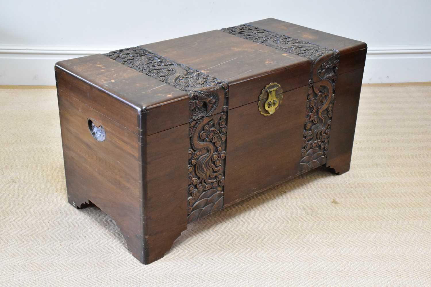 A Chinese carved camphor wood blanket box, height 53cm, width 101cm.