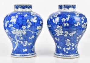 A pair of 19th century Chinese blue and white vases with prunus decoration, height 34cm (one af) (