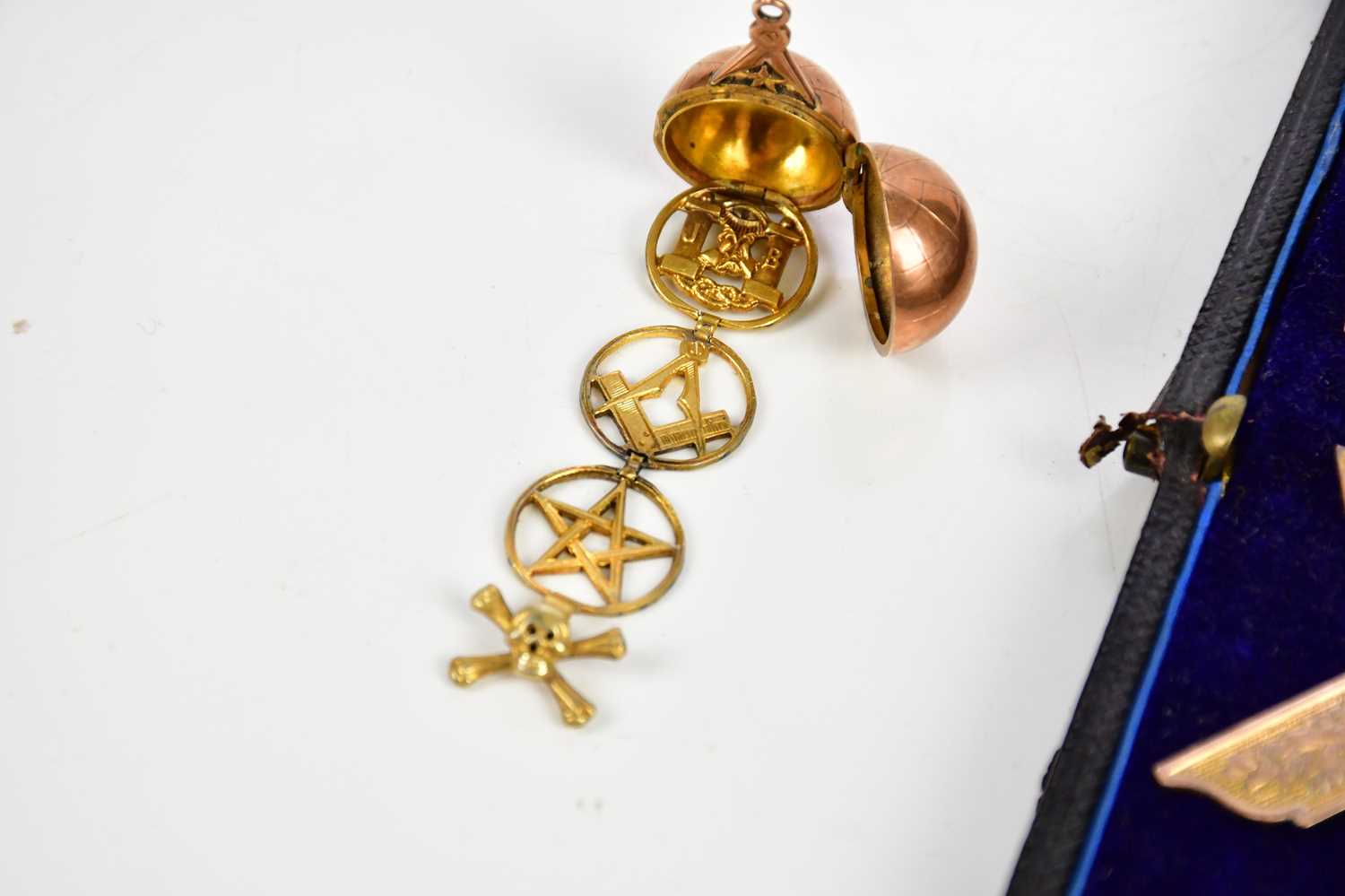 A 9ct rose gold Masonic orb, enclosing Masonic symbols and skull and crossbone, and a 9ct gold - Image 2 of 4