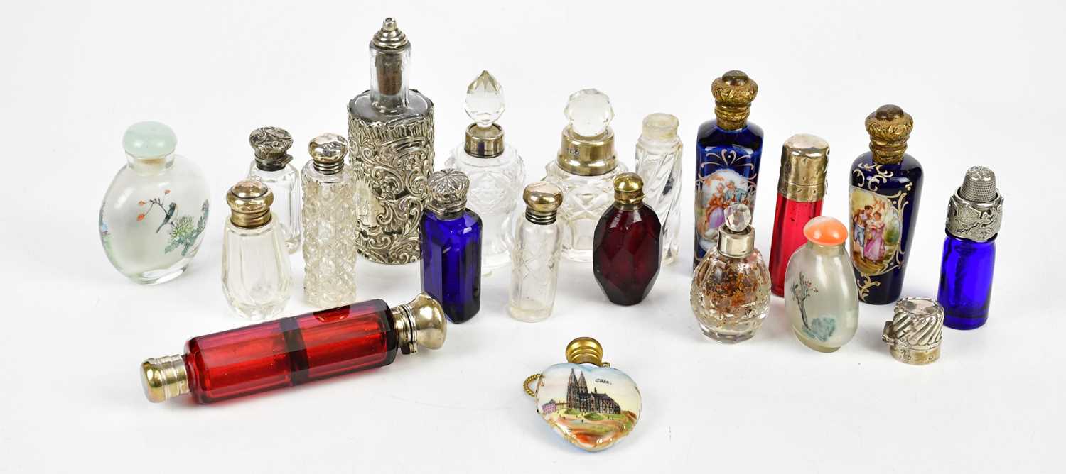 A collection of Victorian and later scent bottles including a clear glass example with hallmarked