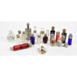 A collection of Victorian and later scent bottles including a clear glass example with hallmarked