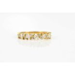 An 18ct yellow gold diamond set dress ring set with marquise and round brilliant cut diamonds,
